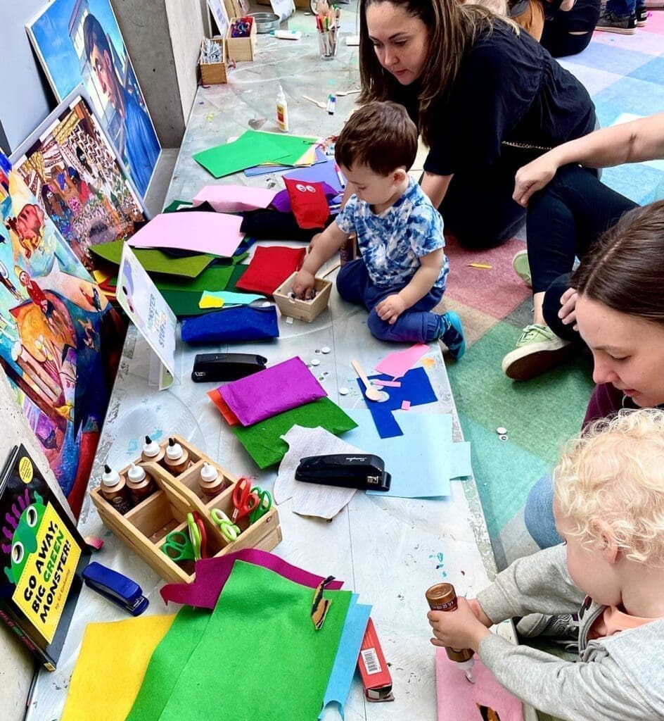 A group of young children works on an arts project.
