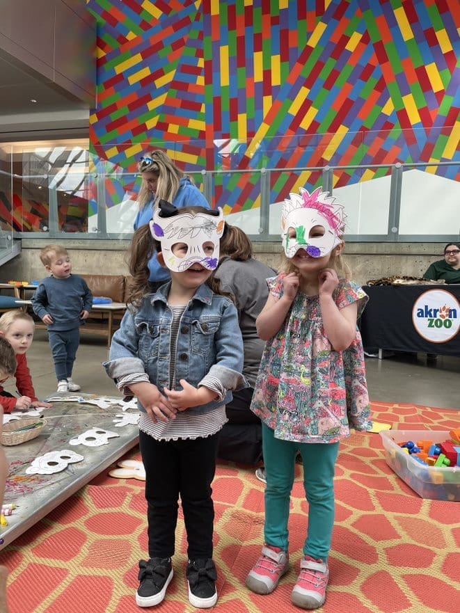 Two children wearing handmade masks.
