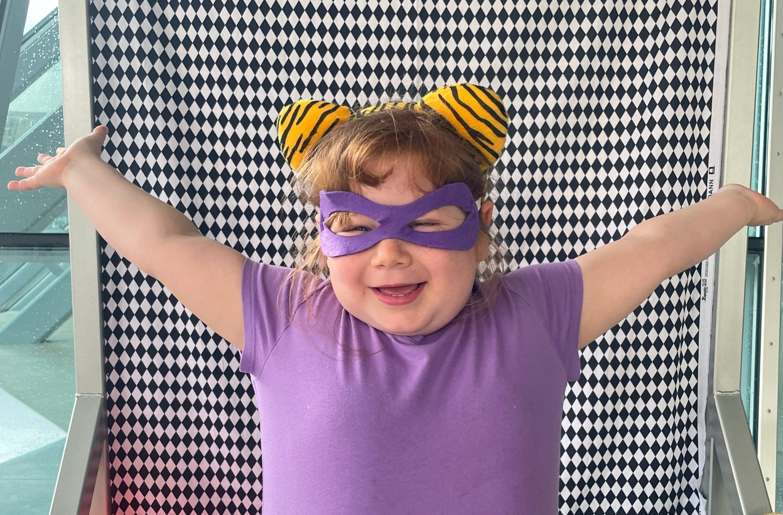 A child wearing purple clothes.