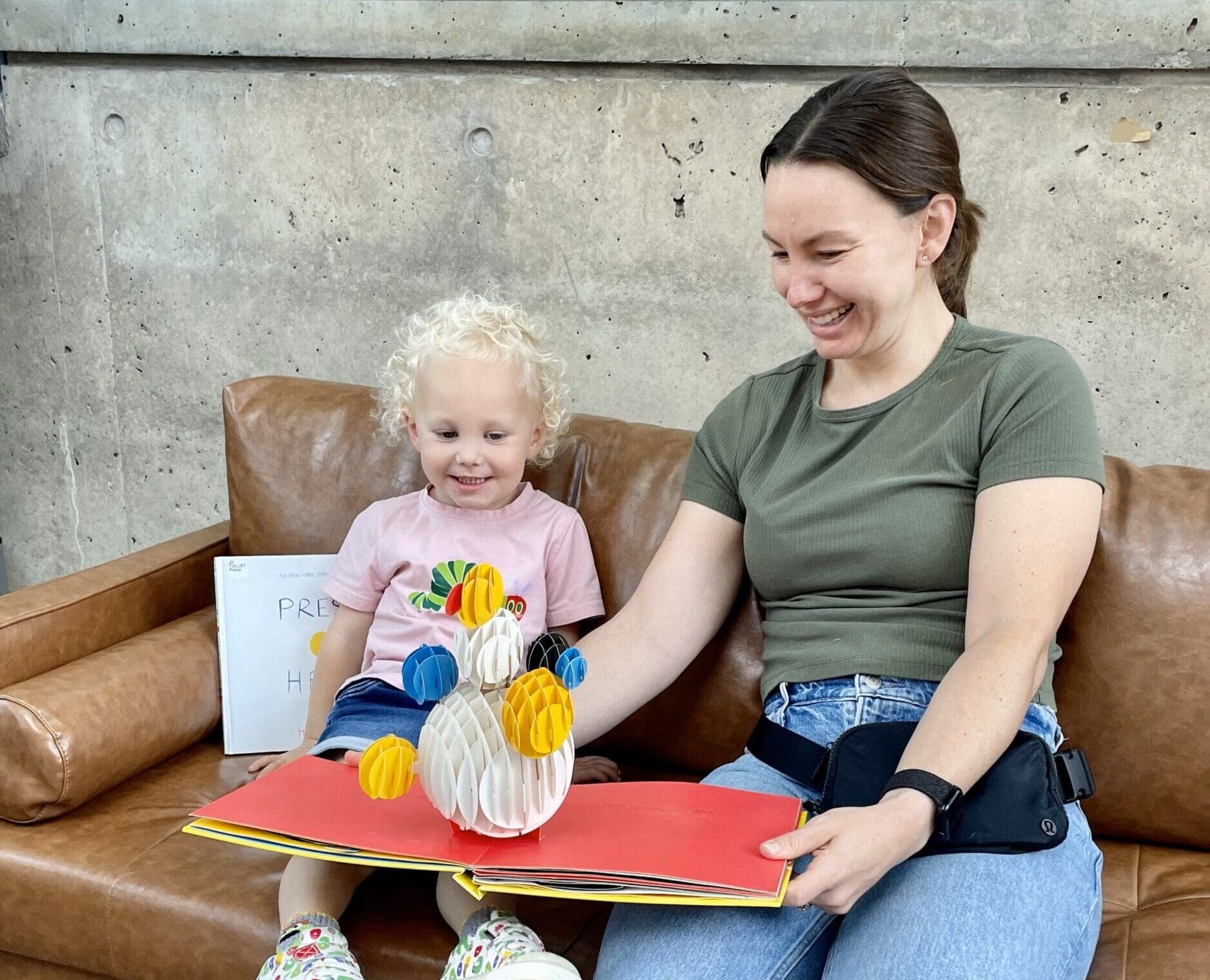 A woman reading to a young child.