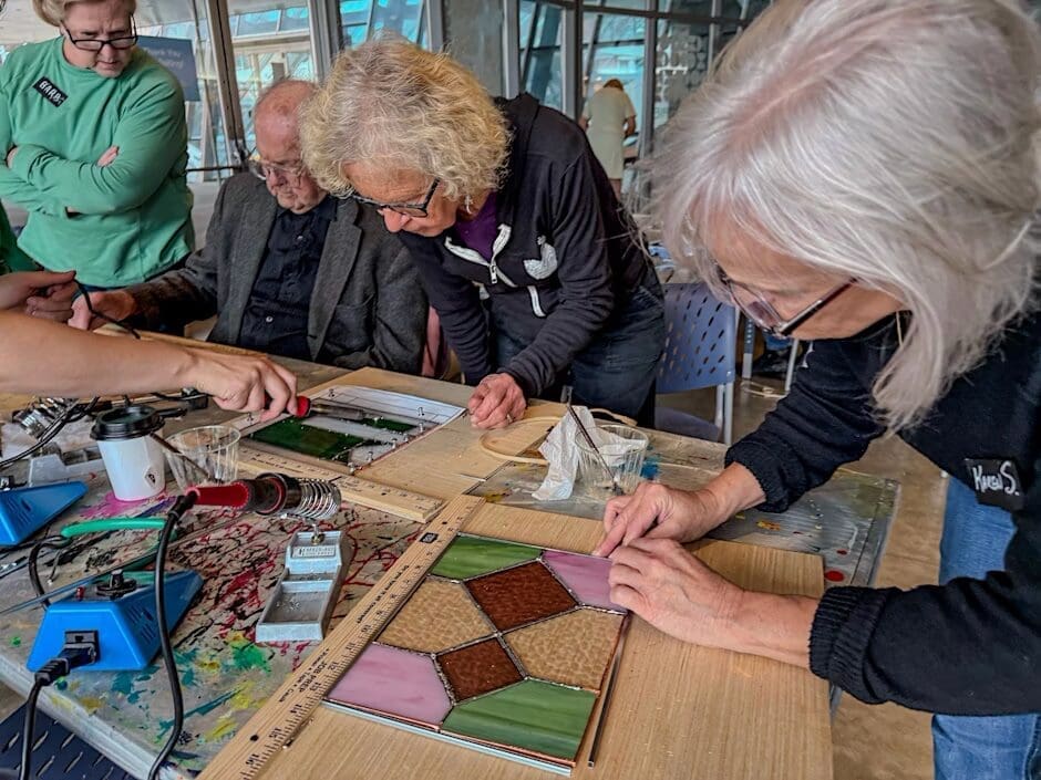 A group of 55+ adults working on a mosaic.