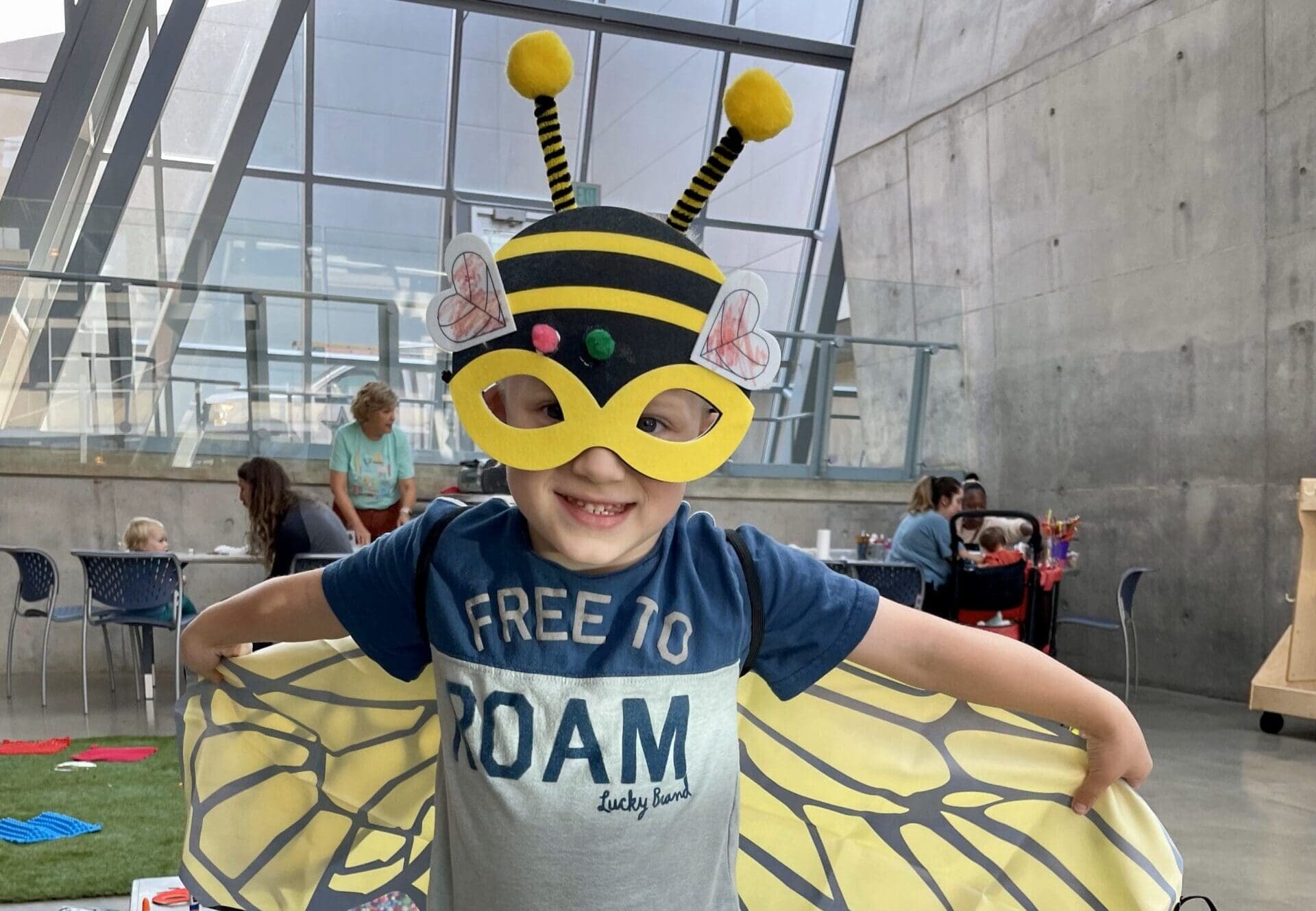 A young child dressed in a bee costume at the Akron Art Museum.