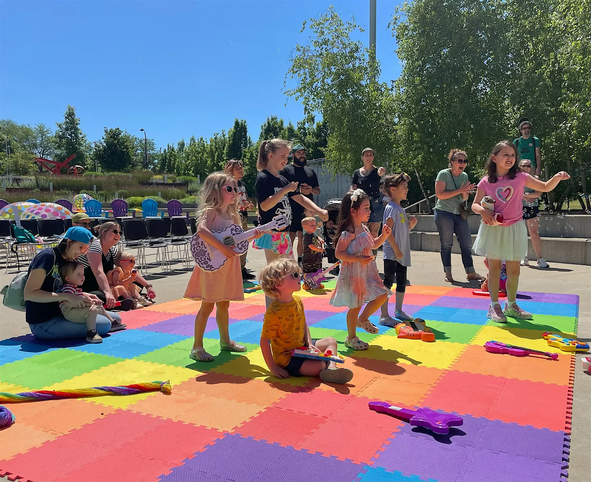 Kids singing and playing music in the Akron Art Museum's Bud and Susie Rogers Garden.