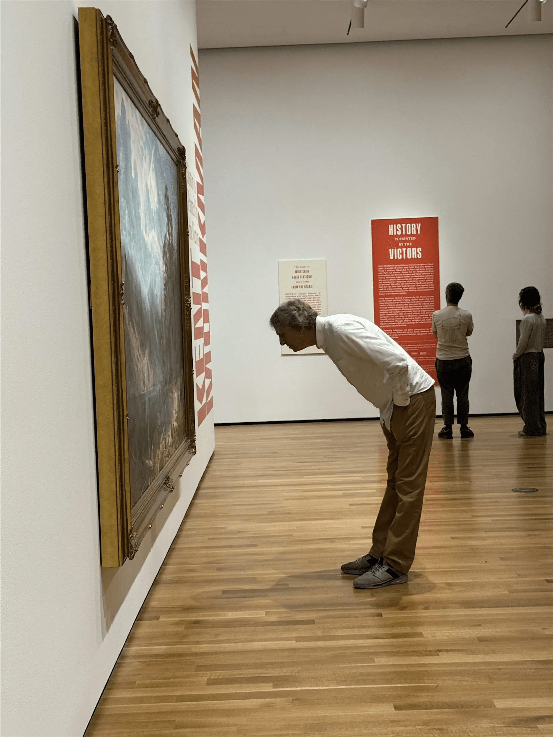 A man looking at art on the walls of the Akron Art Museum