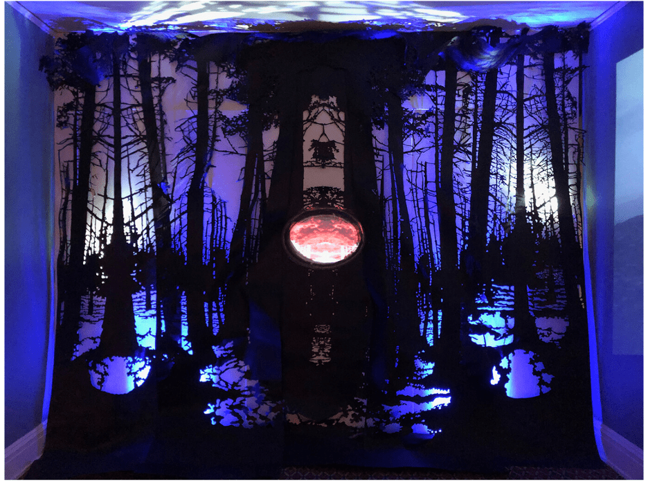 Alice Pixley Young, Fearful Symmetry, 2019, Hand cut roofing paper, cast glass, three channel video, sound, LED, Installation image at Taft Museum of Art, Cincinnati, Ohio